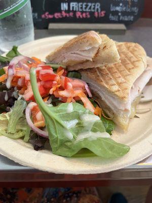 Turkey white cheddar bacon jam panini and side salad with onion dressing