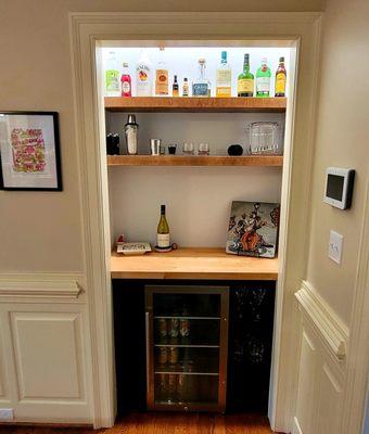 Modern-Rustic take on a wet bar with custom cabinets with built-in wine cubbies. Don't forget about those custom floating shelves!