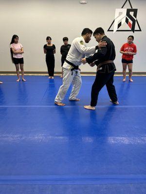 Coach Marco demonstrating technique to our Kids Brazilian Jiu-Jitsu class.