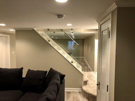 Basement Remodel with glass staircase