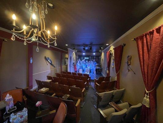 Vintage theater seating, the stage has a drop down projection screen