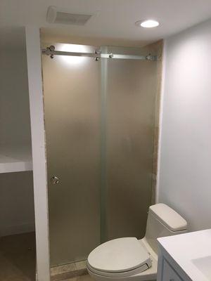 Sliding acid shower door