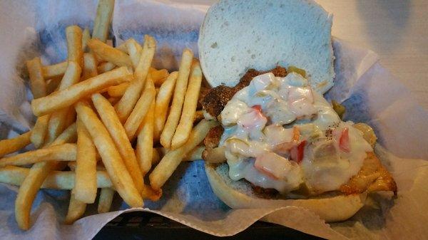 Cajun chicken sandwich with fries .