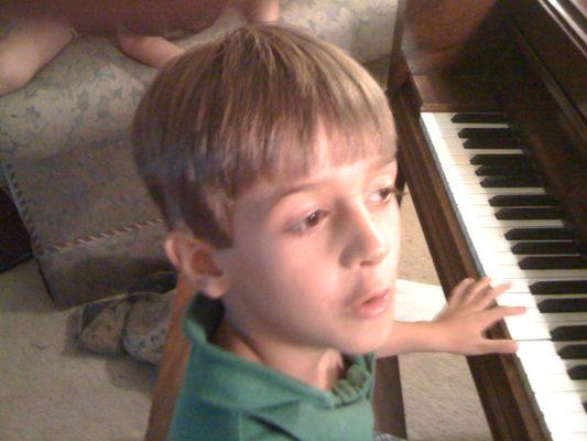 Brynne at his piano lesson