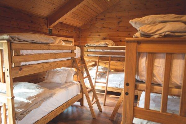 Bunk room in The Loft. Built for adults, these large bunks are insanely comfortable! Pillow-top mattresses and Pottery Barn down comforters.