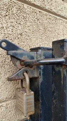 Original gate showing rust and wear from the elements.