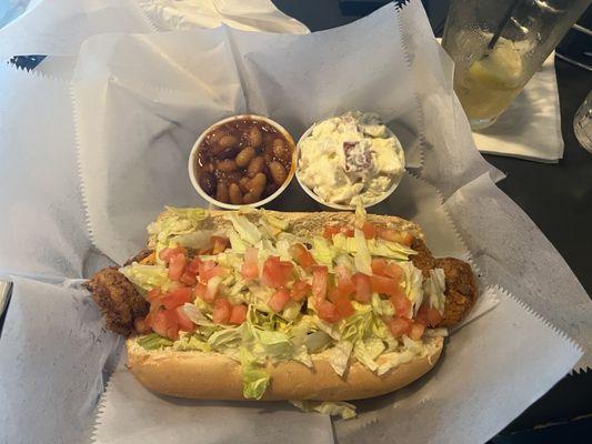 Shrimp po boy sandwich with side of beans and potato salad