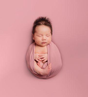 Baby Girl wrapped in cotton candy pink.  photographed at 10 days old.