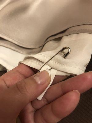 Every shirt has a hole after I asked them to put the safety pin through the hole for the button.