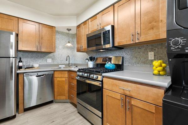 This is our contemporary kitchen style, complete with soft-close cabinetry, glass tile backsplash, and stainless steel appliances.