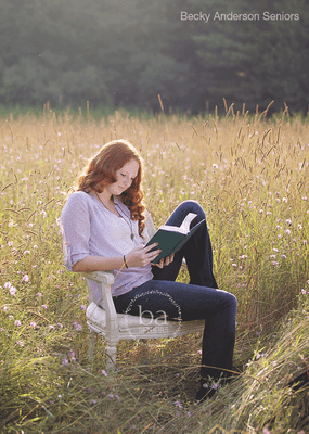 Gorgeous senior in a field  who loves books