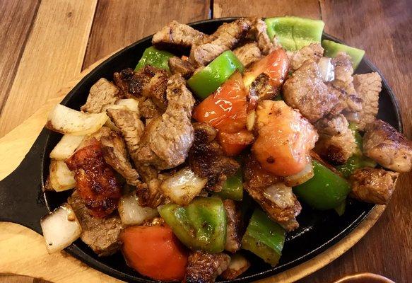 Picadinho do vila - steak with onion and peppers served with rice, beans, salad and fried yucca