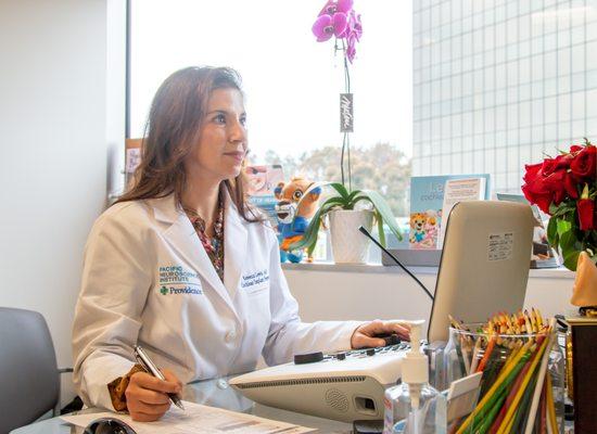 Dr. Lewis performing an Audiology test on a patient.