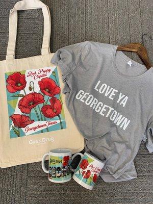 Several Georgetown t-shirts and gift items including coffee mugs, postcards and bags.