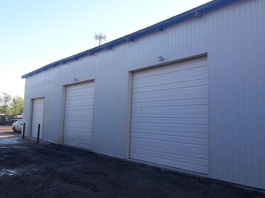 All storage units have 10' x10' front doors & 8' x 8' back doors. 20' High ceilings.  Electrical.  Easy access to dumpster and water.