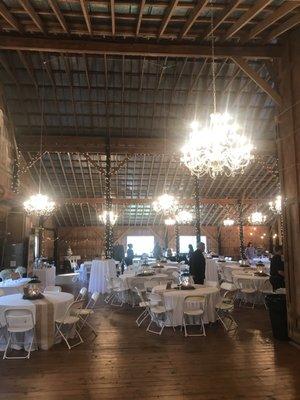 Stark contrast of crystal chandeliers with wooden floors & tin roof make this place one of my favorite wedding venues. It's "Glam-chic"