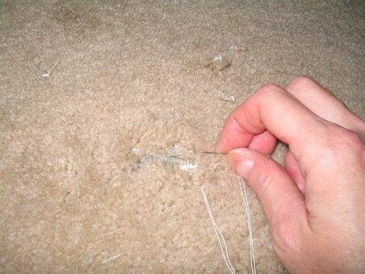 Here I am trying to mend this originally tiny hole in the carpet that gets larger if I touch it with my pinky finger.