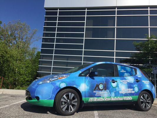 Office building exterior, and the ACI Leaf - an electric car.