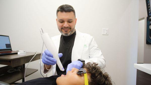 Dr. J examining a patient's mouth