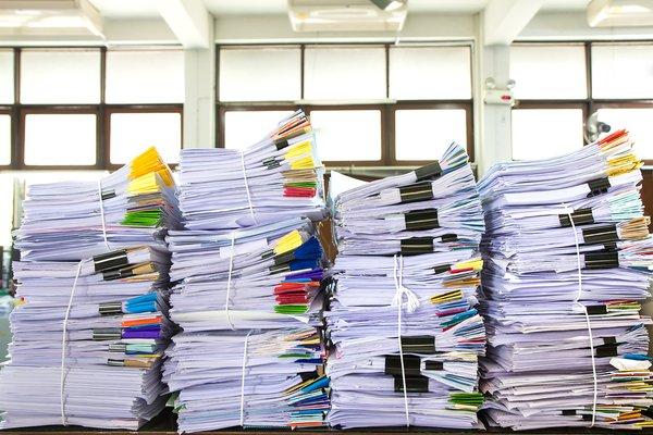 Stacks of paperwork that are ready to be scanned