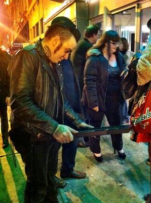 Switchblade Syndicate guitarist Paul Burgio admiring their best punk band award.