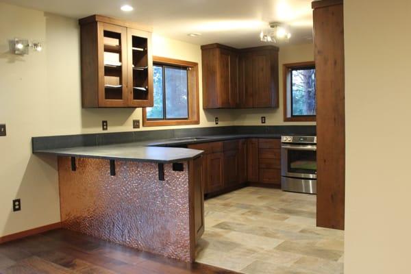 With a soapstone slab, distressed alder cabinets, and a hammered copper island wall, Nash Construction has the skill to create your kitchen.