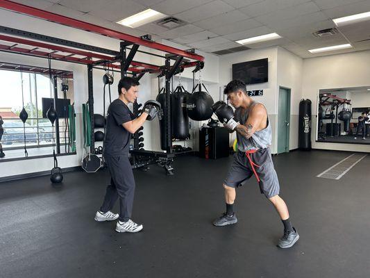 Mitt work drills; develop speed and power in punches by focusing on proper technique and generating maximum force