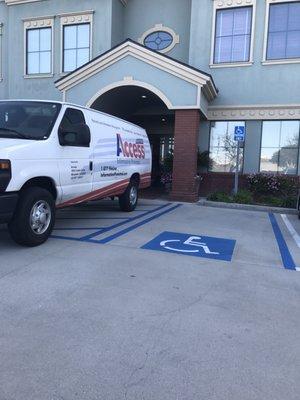 Shame on your driver for parking in a zone reserved for handicap spaces and blocking the entire entrance of an office building