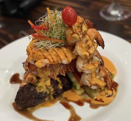 Filet mignon topped with lobster  and grilled drink skewers topped with lobster sauce . To die for !!!!