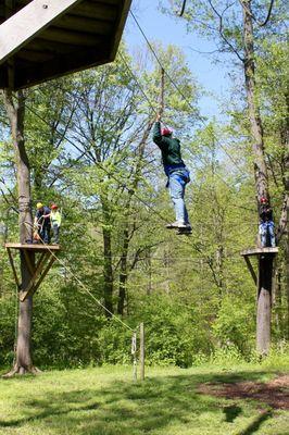 Ropes course that ends with a zip line through the forest