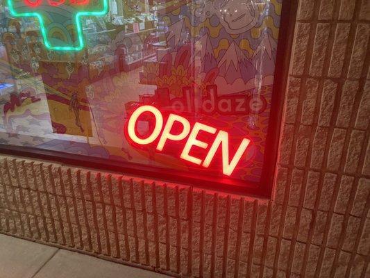 False advertising  Neon sign indicating the store is open when in fact the store is closed