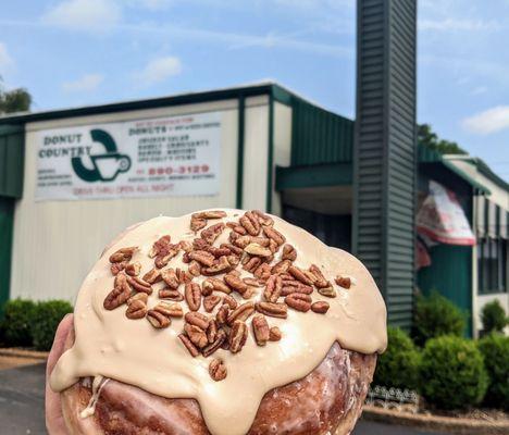 Giant and delicious maple iced cinnamon roll with pecans