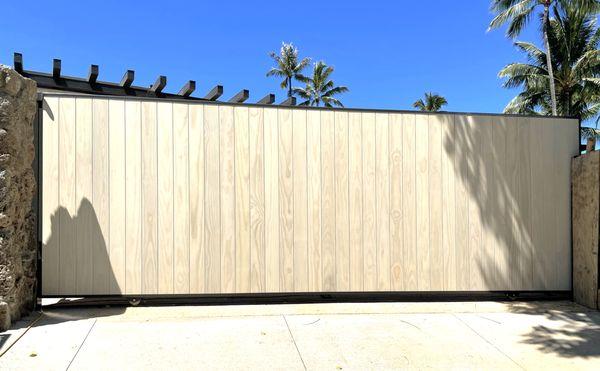 Pure privacy with a custom automatic sliding gate with wooden cladding