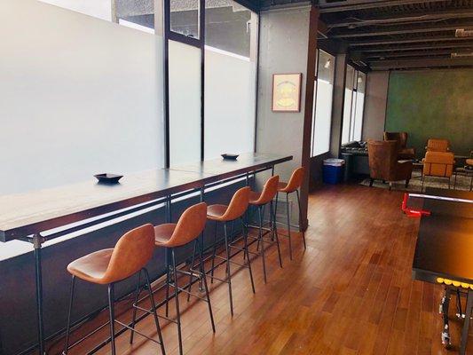 Obolus Room's coworking space with ten chairs and power outlets.