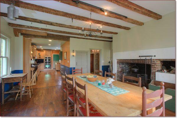 Modern kitchen adjoins colonial keeping room 50 feet in length.