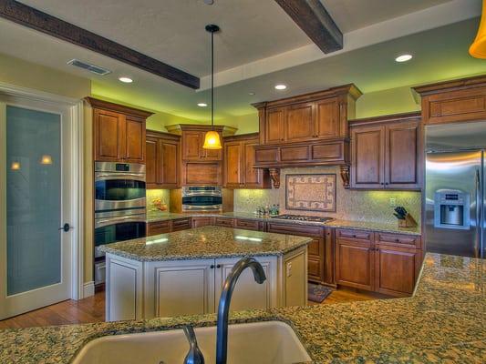 Rocklin custom home kitchen with walk in pantry. The microwave is build into the counter space for clean lines.