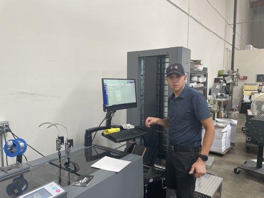 Bindery supervisor setting up booklet maker