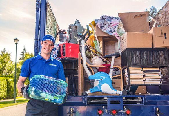 1-800-GOT-JUNK? Long Island East truck team member with a loaded junk truck