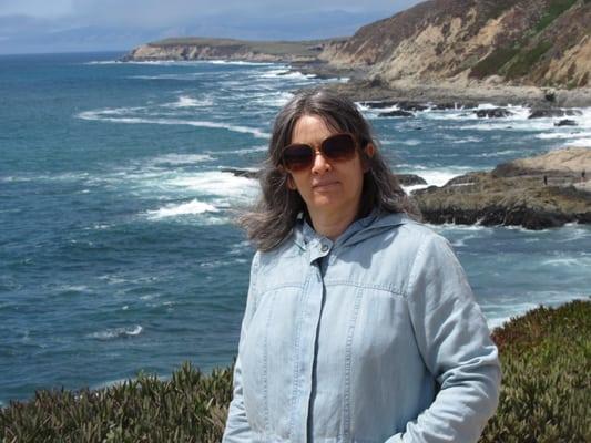 Deborah Olenev in front of the beautiful Pacific Ocean.