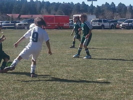 Children playing soccer on a Sunday afternoon