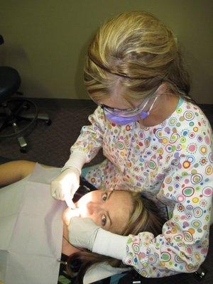 Dental Hygienist assisting a child