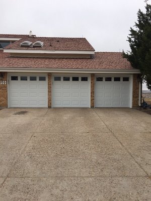 Three new 8x7 short panel doors with windows.