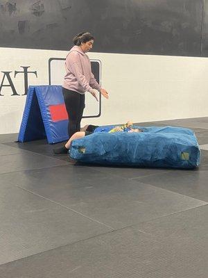 Practicing falling on the mat at Jiu Jitsu for Autism. He loves this crash pad!