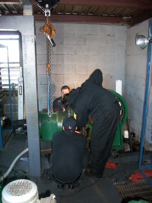 Mechanics repairing on an elevator machine.