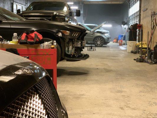 Hood repair on a Bentley coupe, and vinyl wrap on a mustang.