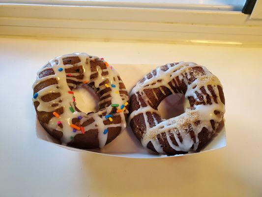 Freshly made donuts - shown birthday cake and cinnamon roll flavors