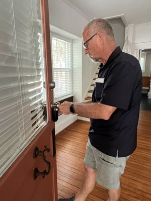 Removing a door knob to rekey the lock cylinder.