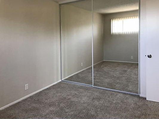 Bedroom with mirrored closet doors