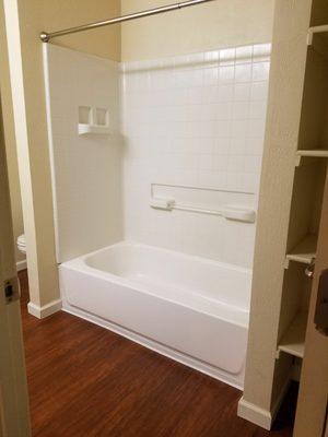 Looking into bathroom of 1bed/1ba from hallway entrance. Nice built in shelves on the right