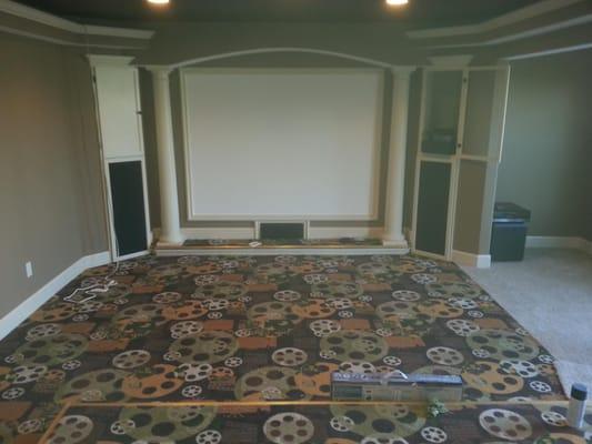 this picture shows a home theater with theater carpeting.